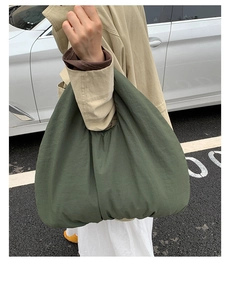 Close-up of olive green oversized hobo tote bag with pleated texture and soft fabric detail