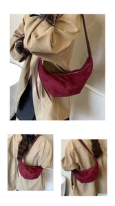 Detail of burgundy suede crescent bag showing smooth texture and adjustable shoulder strap