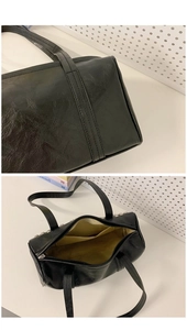 Close-up of black textured leather handbag featuring metallic rivets and internal pockets