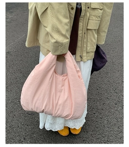 Detailed view of pink quilted tote bag showing large capacity and soft puffy texture