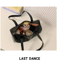 Top view of spacious interior in black studded Boston bag holding daily essentials