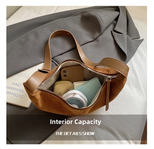 Internal view of the brown suede crossbody bag showing phone, wallet and zipper pocket