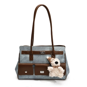 Retro canvas tote bag in light blue with brown leather straps and a plush bear pendant