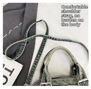 Close-up of adjustable strap and handle on retro washed denim crossbody bag with metal buckle