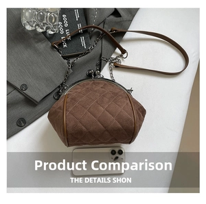 Detail of vintage brown suede shell bag with diamond stitching and metal ball clasp closure