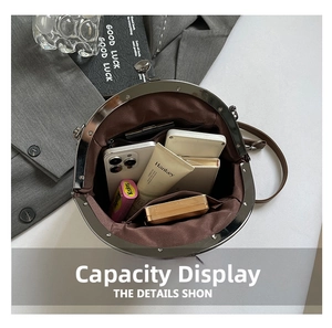 Interior view of vintage clasp bag showing large capacity for phone and cosmetics