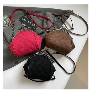 Macro view of retro quilted suede shell bags with vintage metal clasp and chain strap
