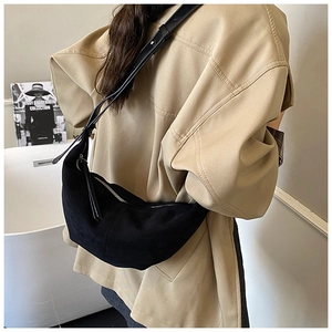 Detail of black suede hobo bag with smooth leather adjustable strap for daily commute