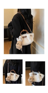 Detail of plush bucket bag with brown leather handles and a cute bear charm pendant