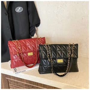 Detailed view of quilted faux leather bags with gold twist locks and chain straps