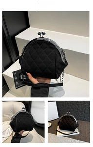 Detail of black quilted velvet shell bag with retro metal clasp and chain strap