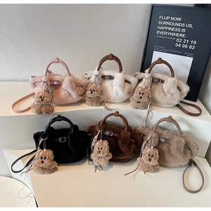 Six colors of fluffy plush bucket bags with teddy charms displayed on a white stand