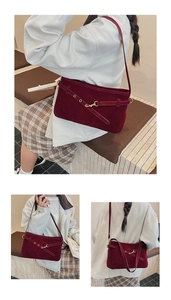 Three-way view of a vintage burgundy suede shoulder bag with gold metal hardware details