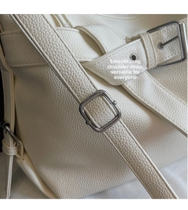 Detailed close-up of high-quality lychee grain leather and silver adjustable buckle