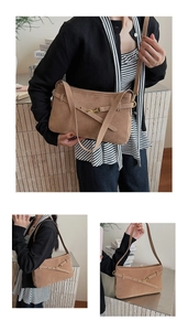 Detail of camel frosted leather hobo bag with vintage gold buckle and shoulder strap