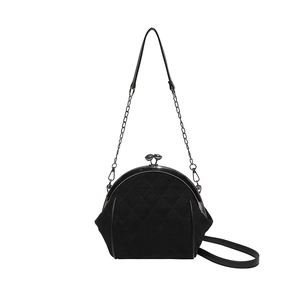 Dettaglio borsa in camoscio nero con trapuntatura a rombi e chiusura kiss-lock in metallo