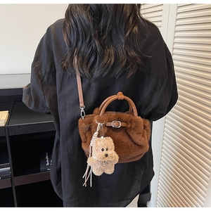 Brown faux fur bucket bag with leather handles and cute plush bear charm detail