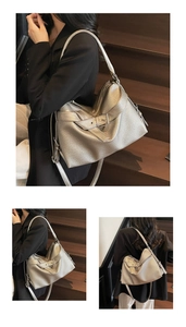 Detail of silver metallic tote bag with lychee texture and decorative buckle strap
