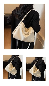 Close-up of white lychee pattern PU leather tote bag with decorative buckle and strap
