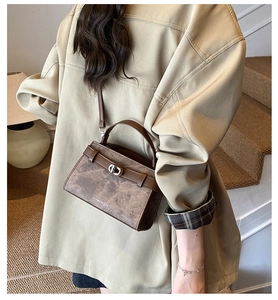 Detail view of the brown vintage crossbody bag with silver buckle and leather strap