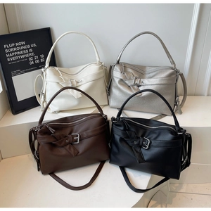 Detailed display of tote bags in white, silver, brown, and black lychee grain leather