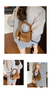Detail of brown suede crescent bag with ruffled handle and decorative bow charms