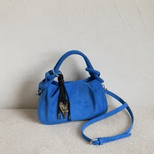 Blue pleated suede shoulder bag with heart pendant and adjustable strap for women