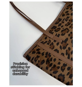 Detailed close-up of precise stitching on durable leopard print tote bag handles