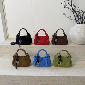 Minimalist pleated dumpling bags in six colors with heart charms and braided handles
