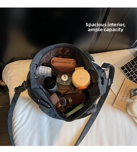 Internal view of a large black canvas tote bag showing spacious compartments and storage