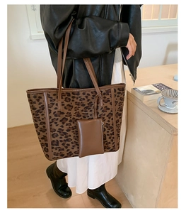 Chic leopard print large tote bag with matching pouch shown on a model in a casual setting