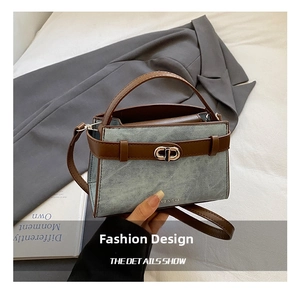 Detail of denim and brown leather bucket bag with silver metal twist lock closure