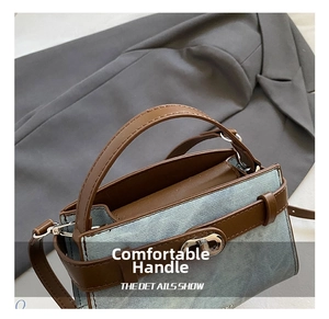 Detail of denim and brown leather handbag with silver metallic twist lock and handle