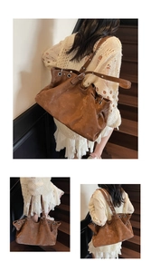 Detail of vintage brown leather tote bag with rivets and eyelets on shoulder strap
