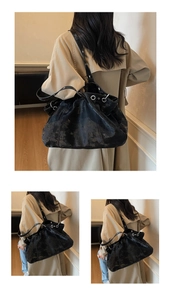Detail view of black vintage tote featuring wrinkled soft leather and silver metal eyelets