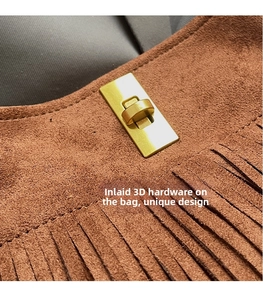 Close-up of brown suede shoulder bag featuring a gold twist lock and stylish fringe details