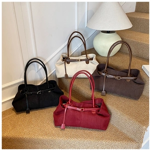 Detailed view of vintage corduroy tote bags in black, beige, brown and burgundy on stairs
