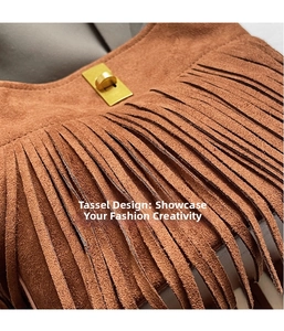 Detailed macro view of brown suede bucket bag featuring long tassels and gold metal clasp