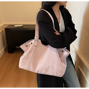 Pink oversized vintage tote bag with retro textured leather and silver eyelet details