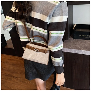 Crossbody bucket bag with grey marble texture and brown leather trim on a model