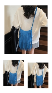 Blue faux suede crossbody bag featuring long bohemian tassels and a slender shoulder strap