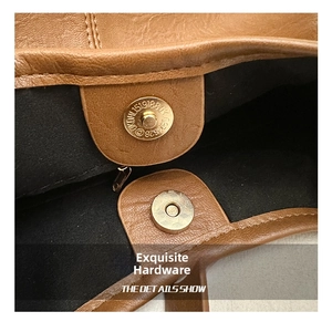 Détail d'un sac en cuir marron montrant le fermoir magnétique doré et la doublure