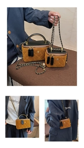 Detail view of quilted denim chain box bags in two sizes with metal flower accents