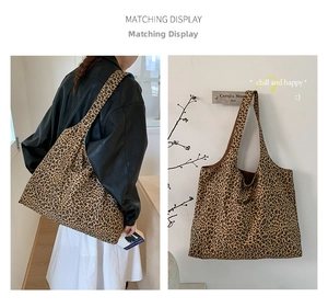 Detail view of large leopard print canvas tote bag showing both on-shoulder and hanging display