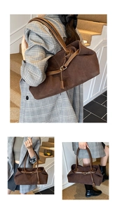 Detail of vintage brown corduroy tote with leather straps and decorative buckle