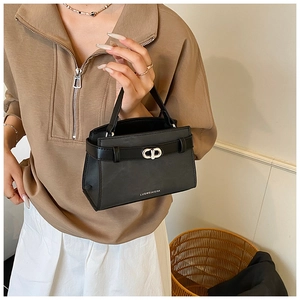 Detail of black faux leather handbag with CD metal buckle and LUOMEINISHA logo