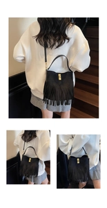Detailed views of black suede fringe bucket bag with golden twist lock and tassel details