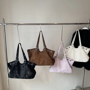 Retro distressed tote bags with metal studs shown in four vintage colors on hangers