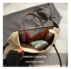 Macro shot showing large interior capacity of the beige corduroy tote bag with brown straps