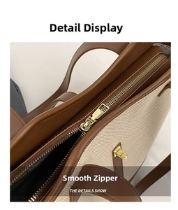 Detailed view of the smooth golden metal zipper and brown leather trim on canvas tote bag